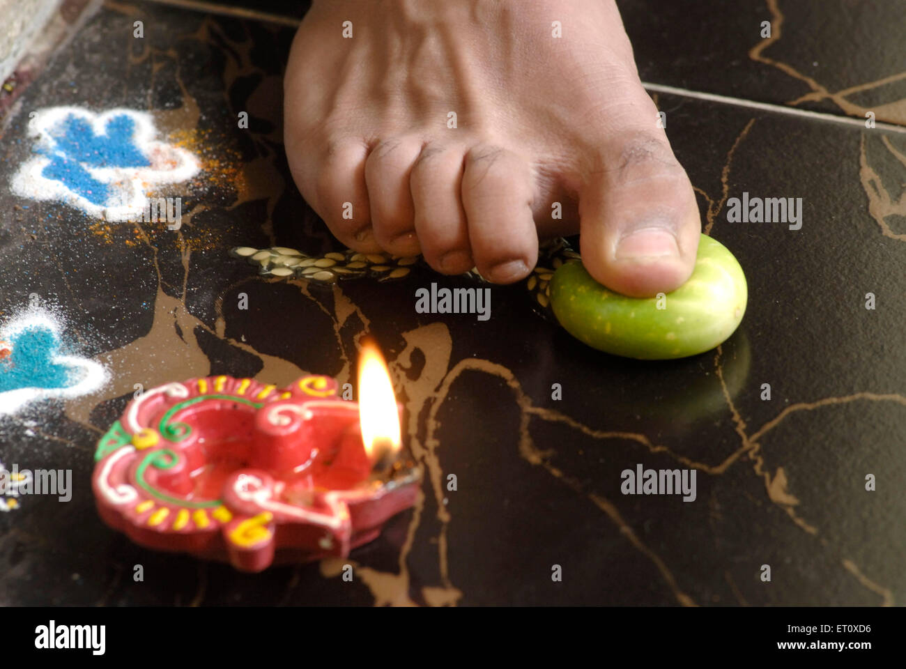 Toe breaking bitter fruit Narak Chaturdashi celebration Diwali festival India Stock Photo
