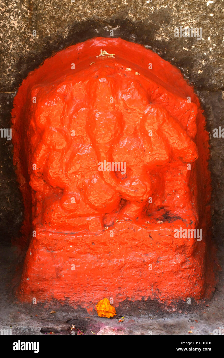 Stone carved statue of lord Ganesh made in scarlet colour at Shree Vishnu Narayan temple on top of Parvati hill ; Pune Stock Photo