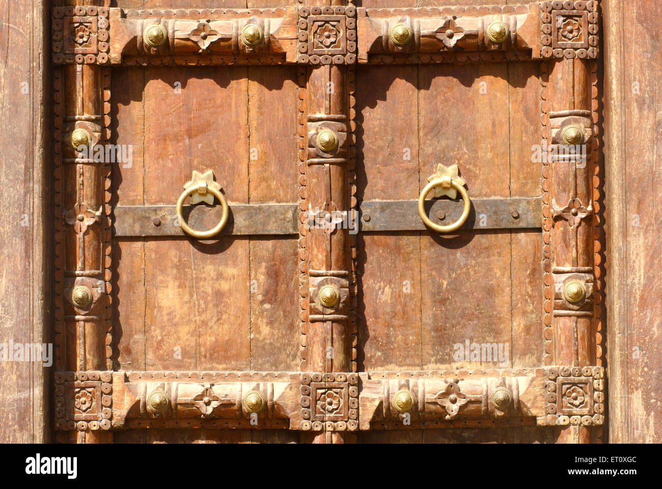 Close view richly wood carved door fixed in brickwork entrance of Vishrambaug Wada second palace Peshve Maratha king ; Pune Stock Photo
