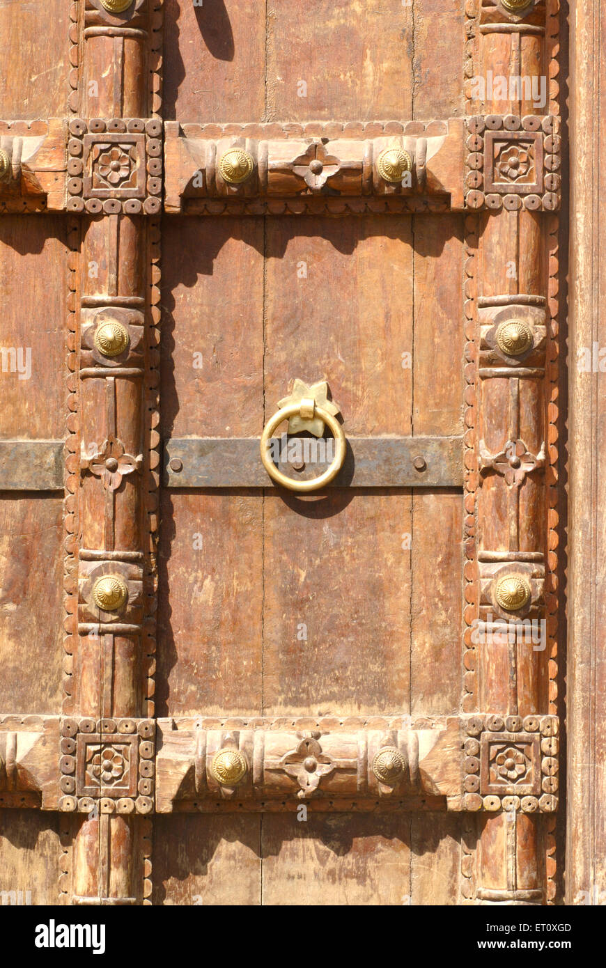 Close view richly wood carved door fixed brickwork entrance of Vishrambaug Wada second palace of Peshve Maratha king ; Pune Stock Photo