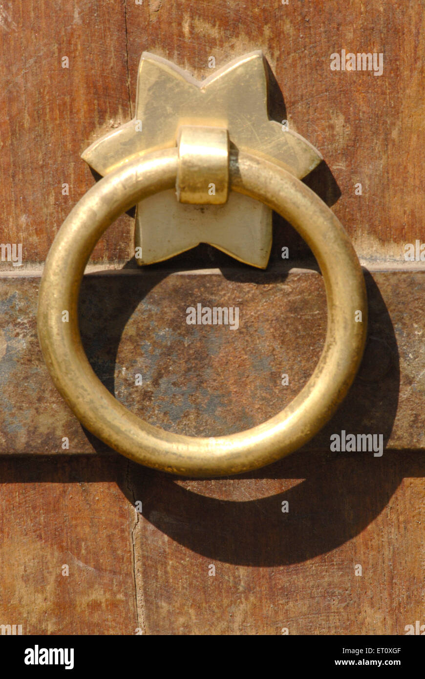 Close up round decorative brass handle fitted on door Vishrambaug Wada second palace of Peshve the Maratha king ; Pune Stock Photo