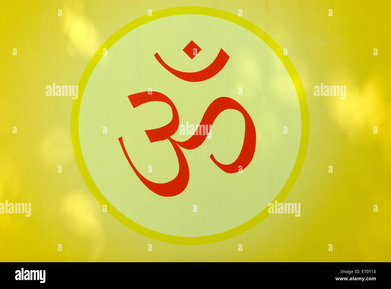 OM cosmic creation holy symbol of Hindu painted in red color ; Pune ; Maharashtra ; India Stock Photo
