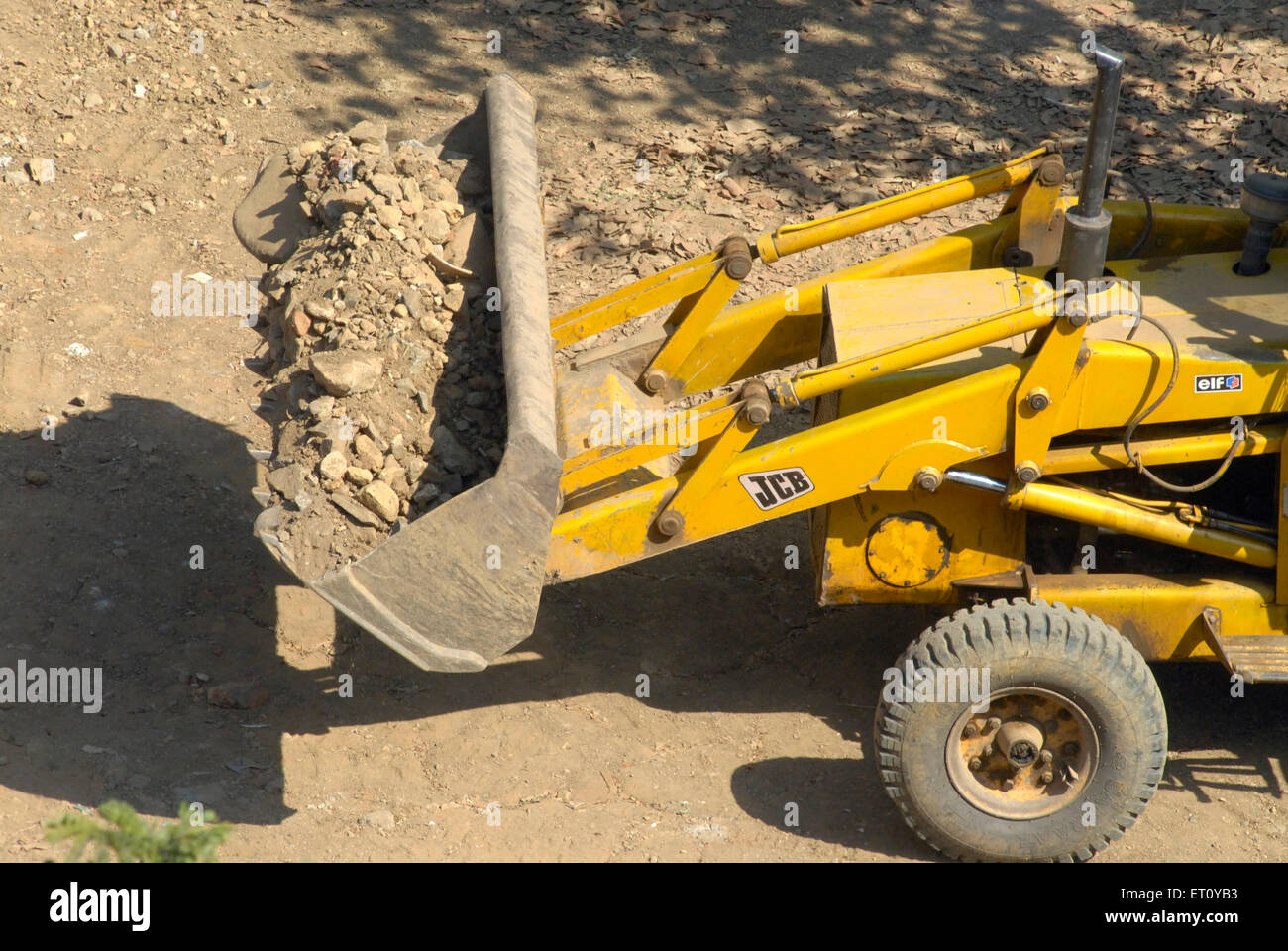 Loaded power shovel of bulldozer excavator and digger jcb heavy machinery at work ; Borivali ; Bombay Mumbai Stock Photo