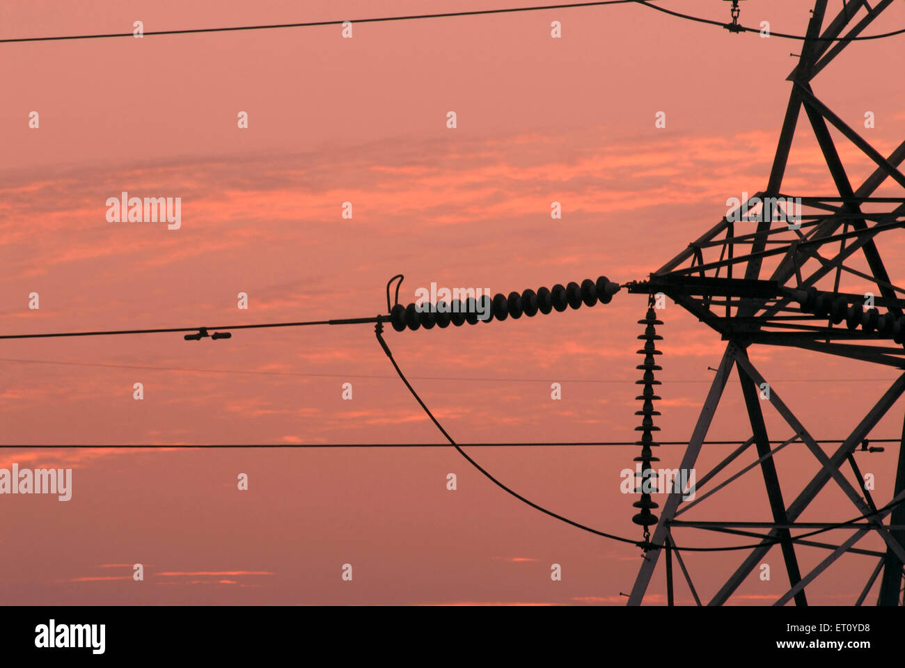 Close up of connections of high tension line tower at sunset ; Pune ; Maharashtra ; India Stock Photo