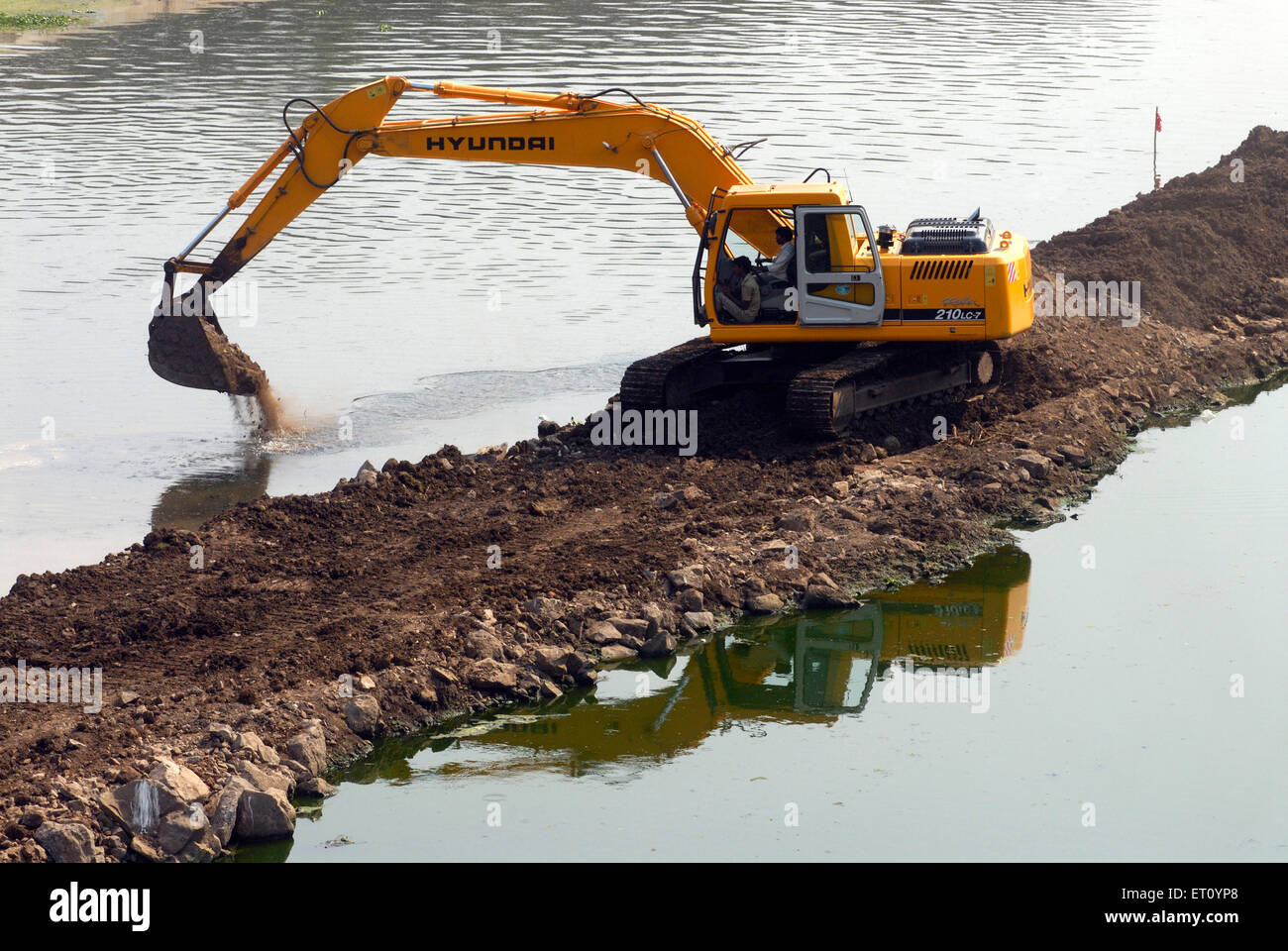 Excavator and digger Bulldozer of HYUNDAI Rolex 210 LC 7 heavy machinery ;  excavation work at bank river Mutha Pune Stock Photo