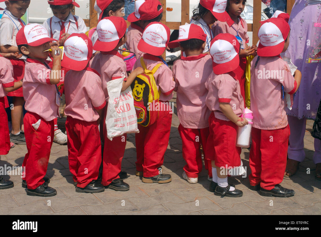 Children in school uniform standing in queue, Kala Ghoda, art festival, Bombay, Mumbai, Maharashtra, India Stock Photo