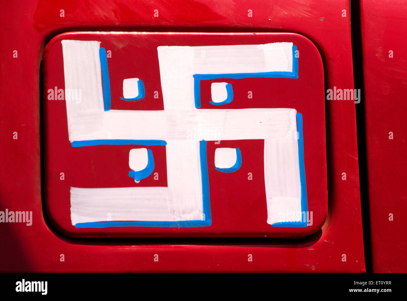 White Swastika on red background painted on truck  ; Bombay Mumbai  ; Maharashtra  ; India Stock Photo