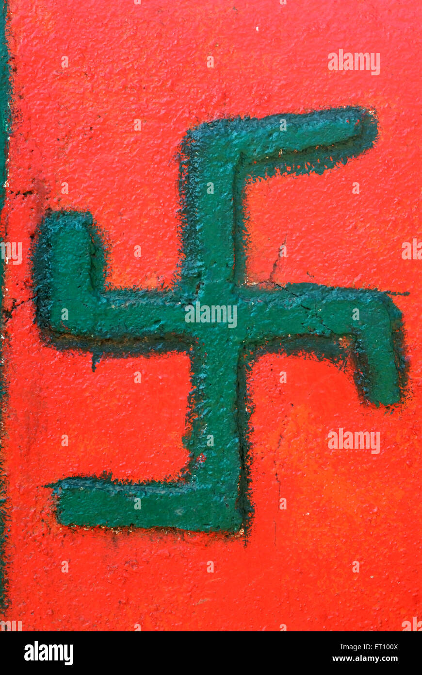 Green swastika on scarlet background holy sign of hindu Stock Photo