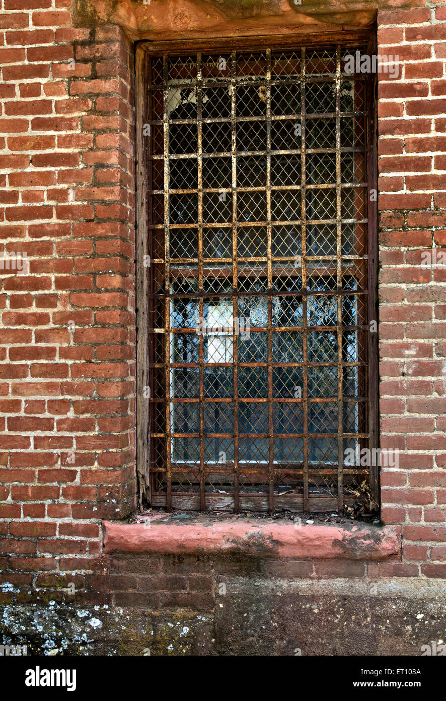 Rusty barred screened window. Stock Photo