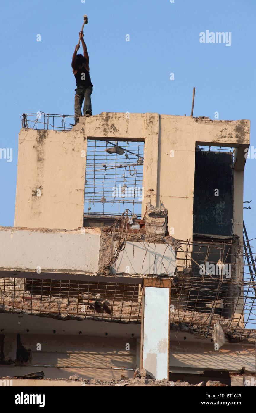 Labor breaking wall of building ; Bombay ; Mumbai ; Maharashtra ; India ; Asia Stock Photo