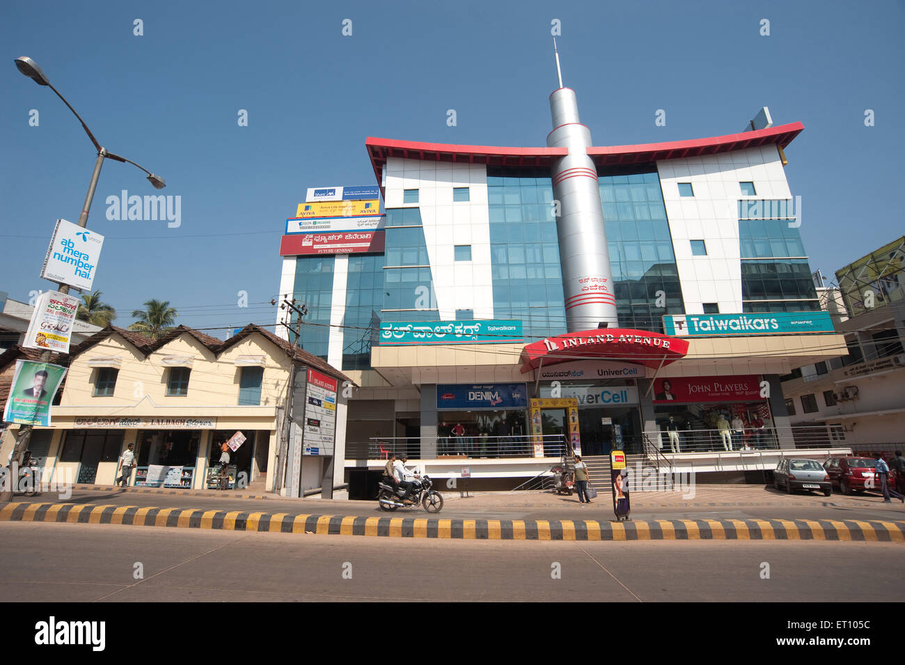Old structure and modern building ; Mahatma Gandhi road ; Mangalore ; Karnataka ; India 2010 Stock Photo