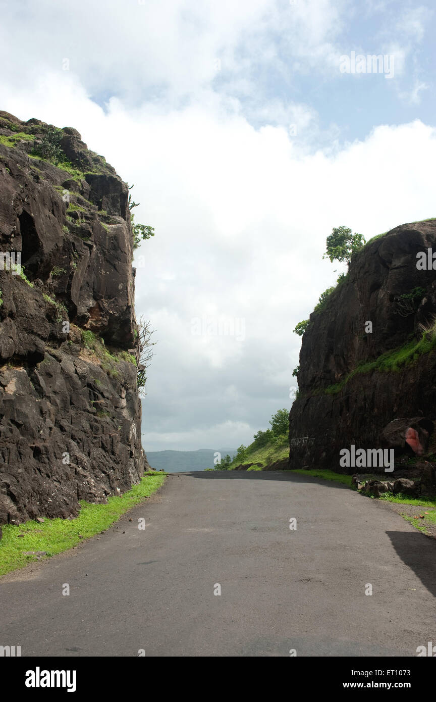 Road through rocks at Ganeshkhind Ghat ; Thane ; Maharashtra ; India ; Asia Stock Photo