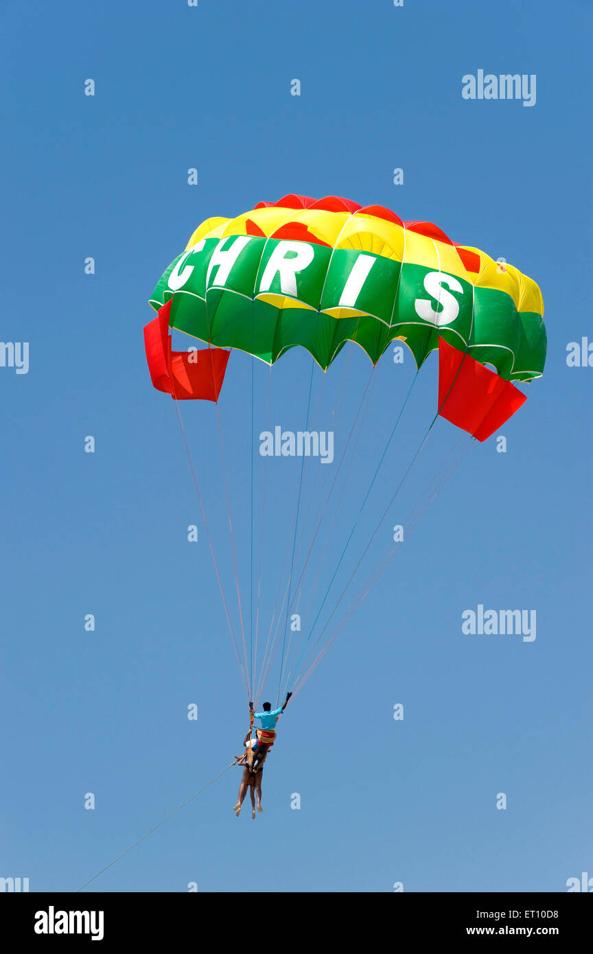 Tourist enjoying parachute ride at colva beach ; Goa ; India Stock Photo