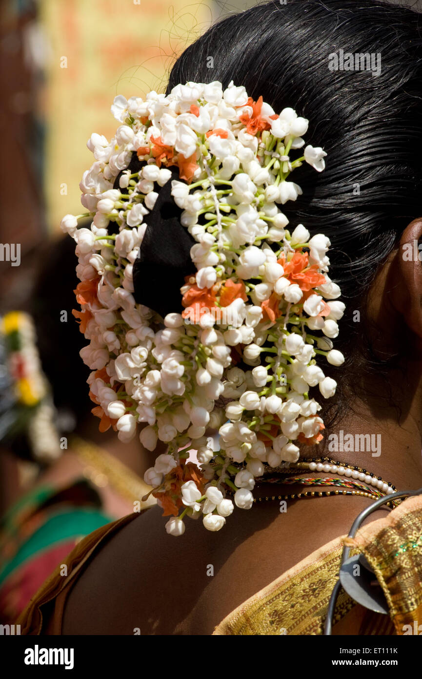 Woman wearing colourful flowers in their hair Thane Maharashtra India Asia 201 Stock Photo