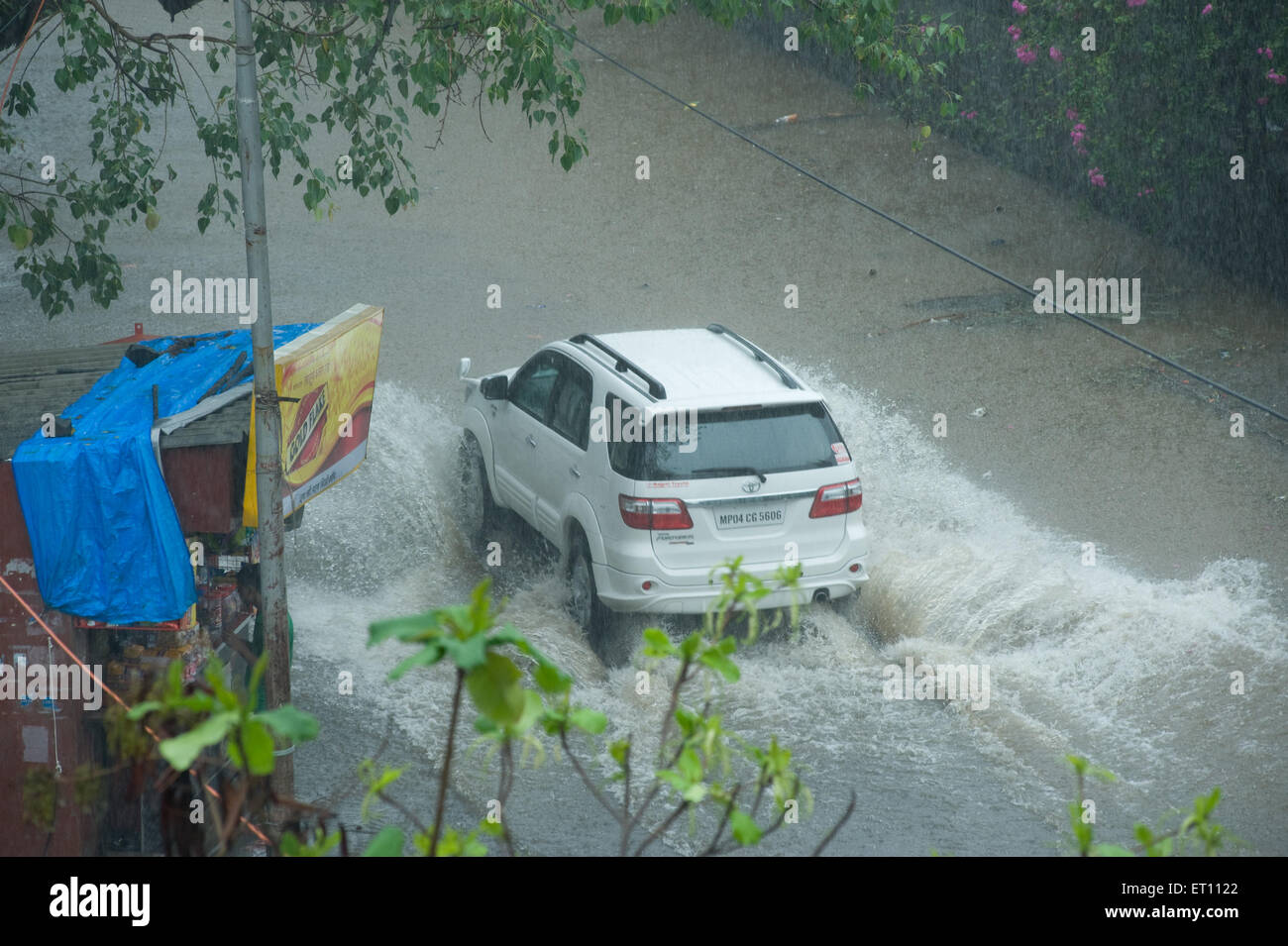 Car moving on flooded road monsoon season at Juhu Mumbai India Asia Stock Photo