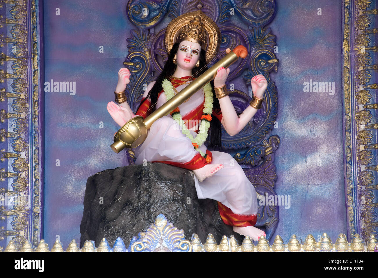 Idol of Saraswati playing musical instrument at Pune Maharashtra India Asia 2011 Stock Photo