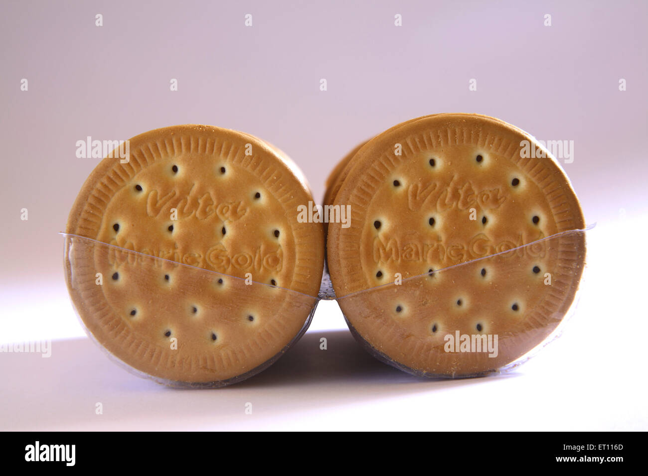 Biscuit dry sweet plain cake pale brown in plastic crate on white background Stock Photo