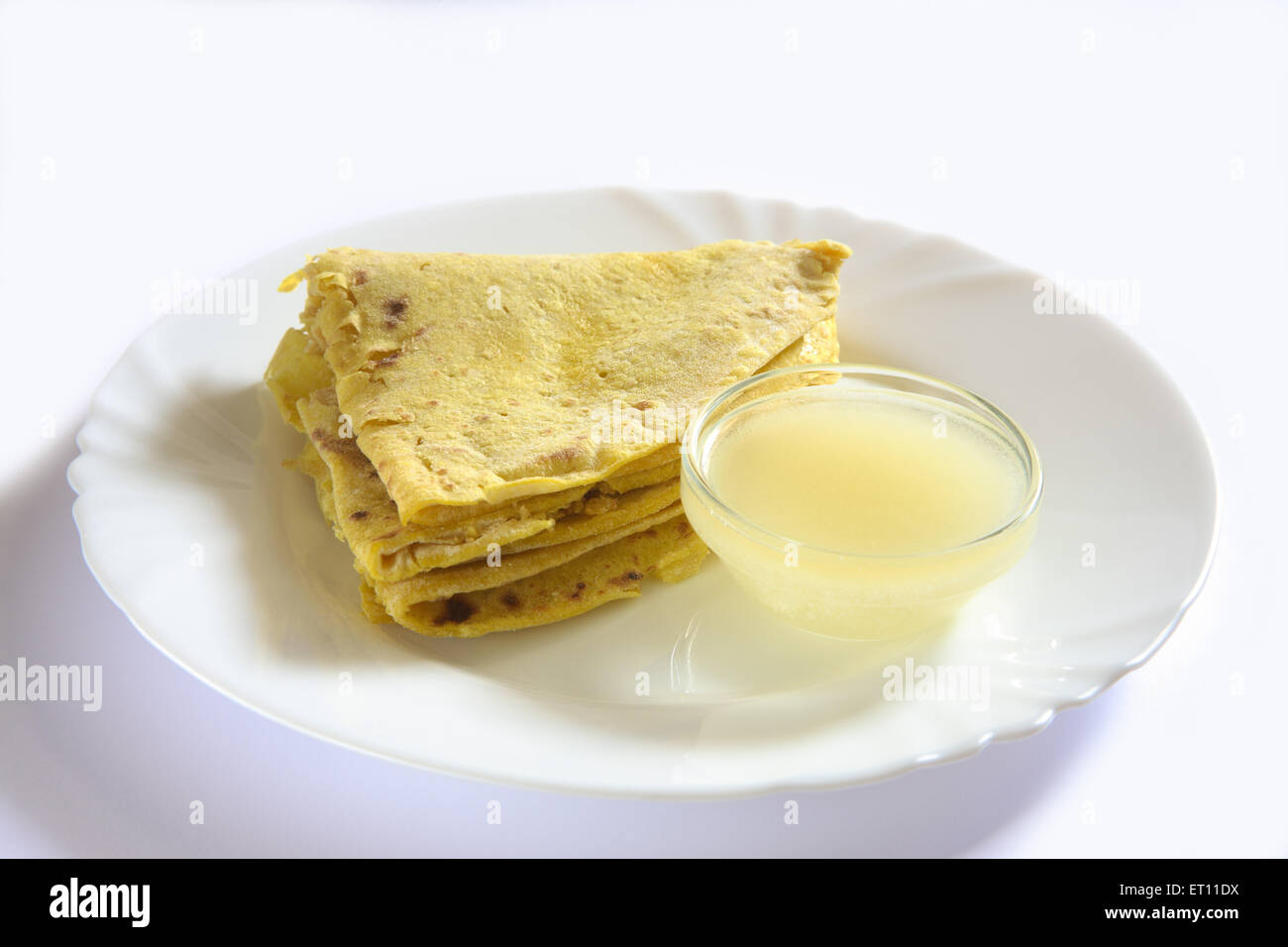 Puran poli with ghee in bowl on plate on white background Stock Photo ...