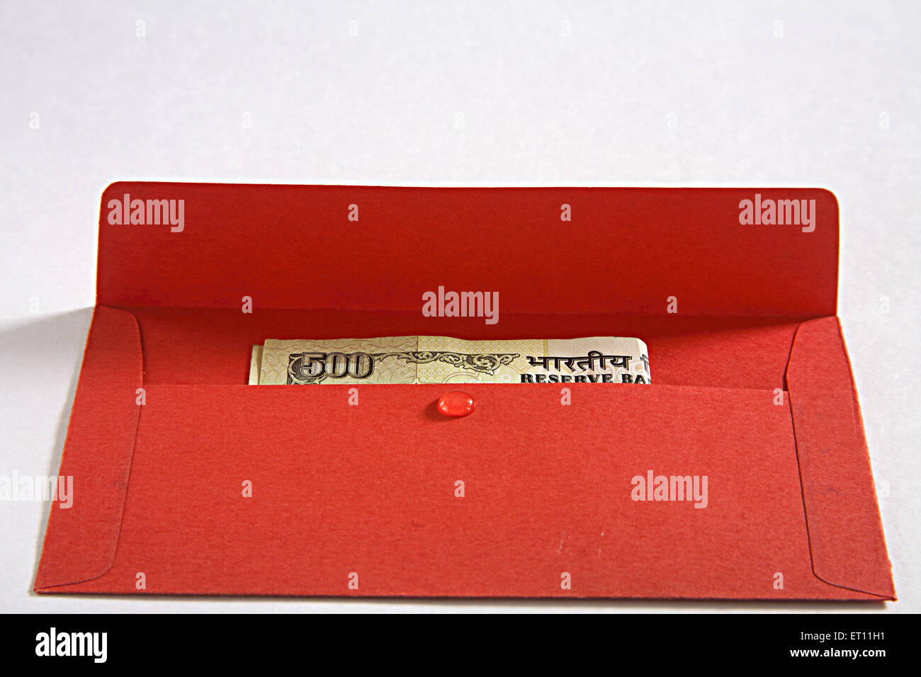 Gond gum birdlime mastic ; red pocket with money inside ; India Stock Photo