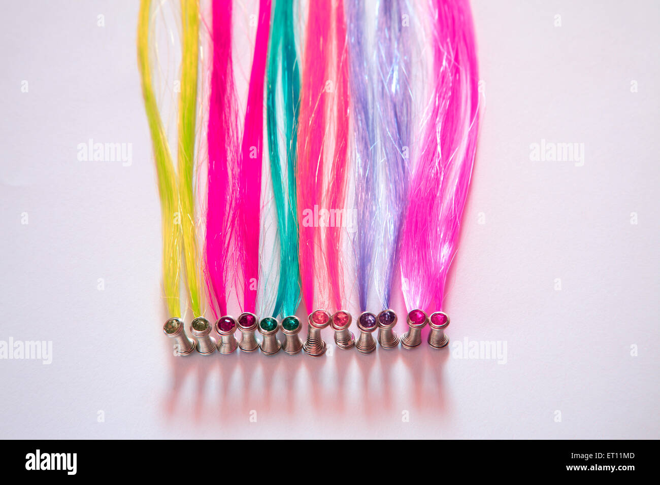 Artificial hair, plastic hair, colorful hair, colourful hair, colorful plastic, colourful plastic, soft plastic, white background Stock Photo