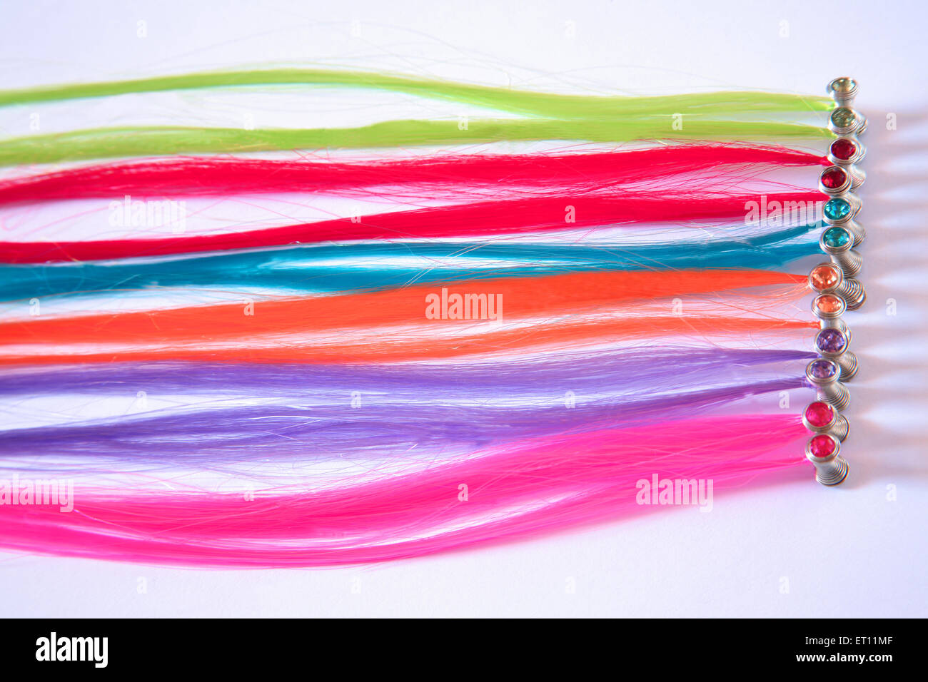 Artificial hair, plastic hair, colorful hair, colourful hair, colorful plastic, colourful plastic, soft plastic, white background Stock Photo