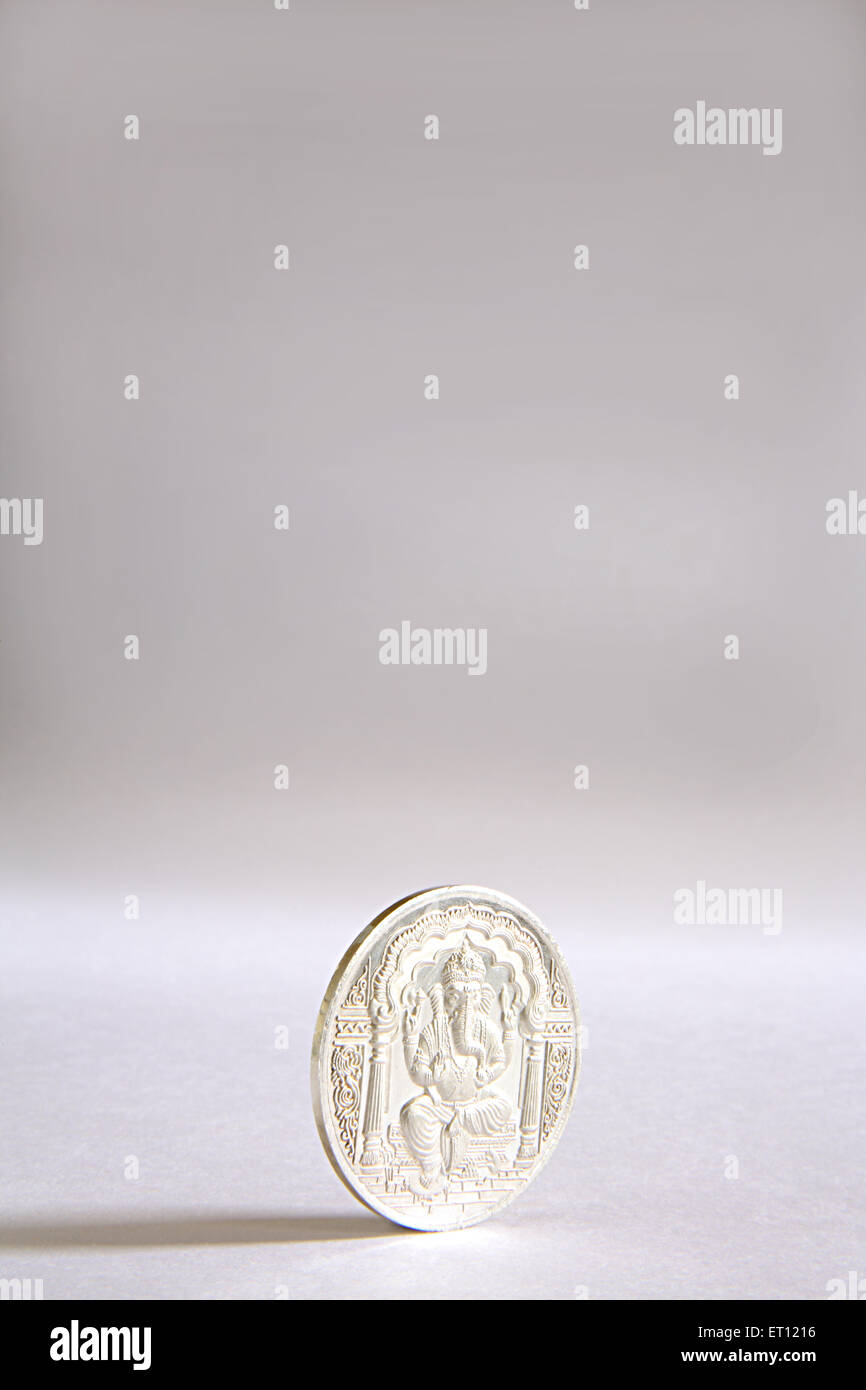 Silver coin with God Ganesh picture , India Stock Photo