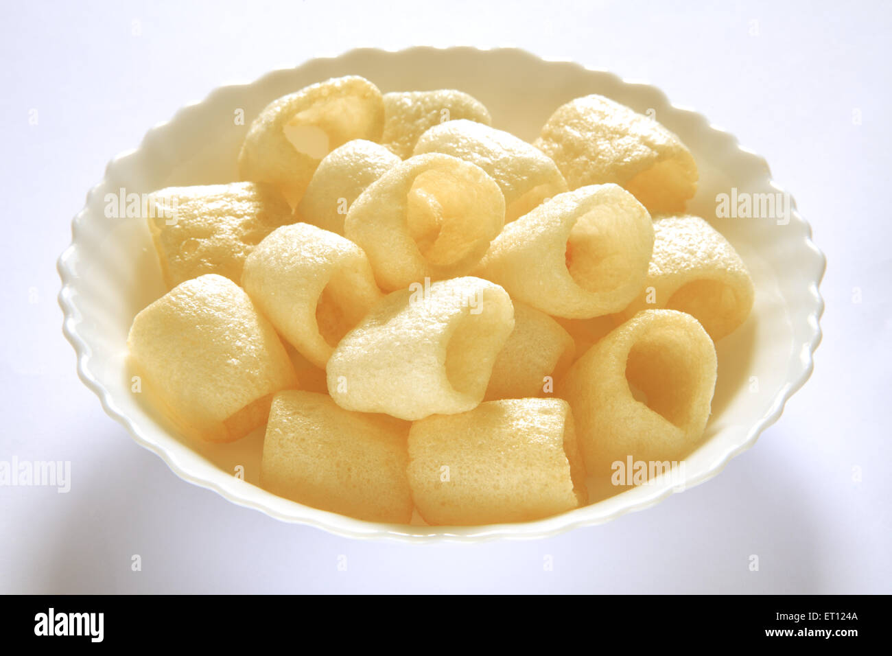 Roasted round chips in bowl on white background Stock Photo