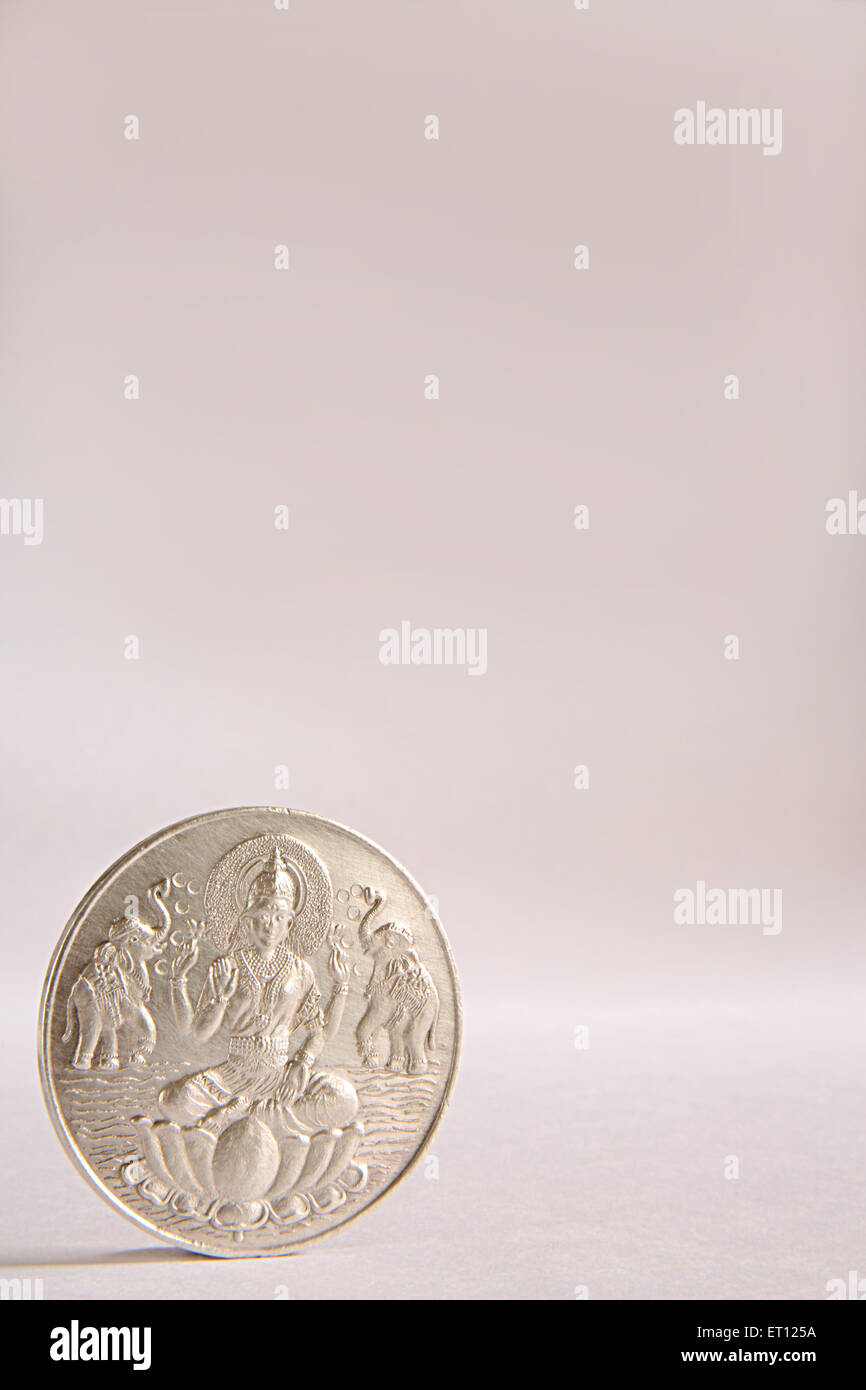 Silver coin with goddess Lakshmi picture ; India Stock Photo