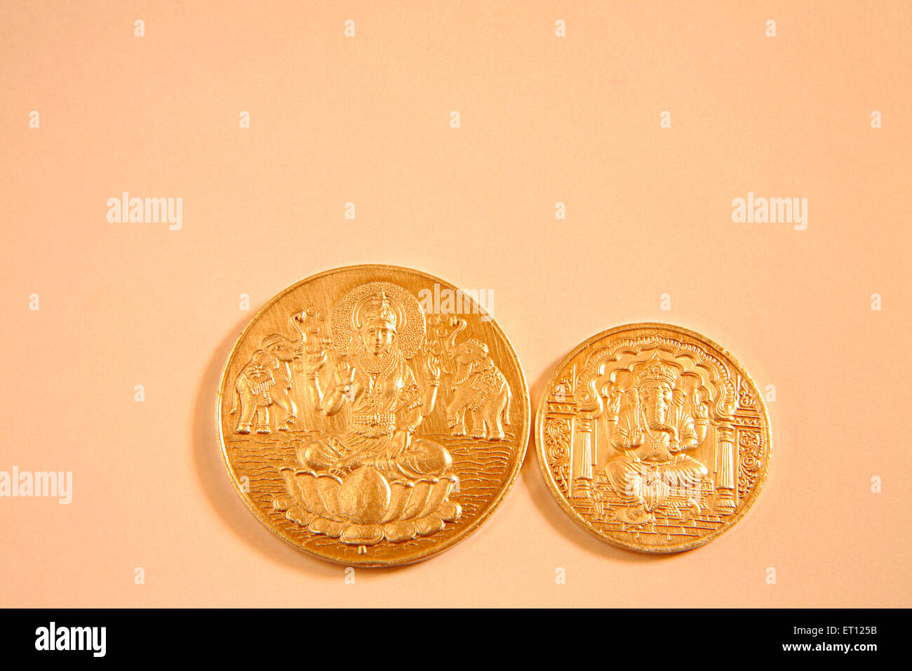 Gold coins with god Ganesh and goddess Lakshmi picture ; India Stock Photo