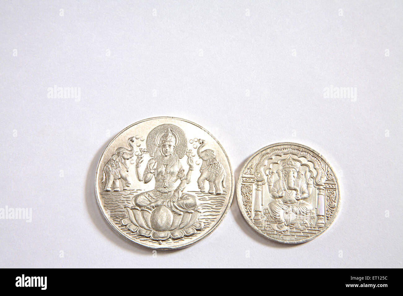 Silver coins with god Ganesh and goddess Lakshmi picture ; India Stock Photo