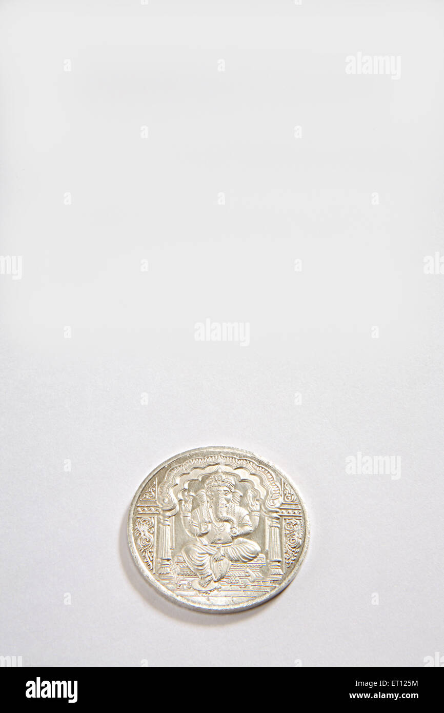 Concept ; silver coin of god ganesh on white background Stock Photo