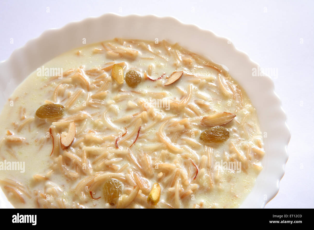 vermicelli pudding , sweet sevian , milk nuts saffron in bowl on white