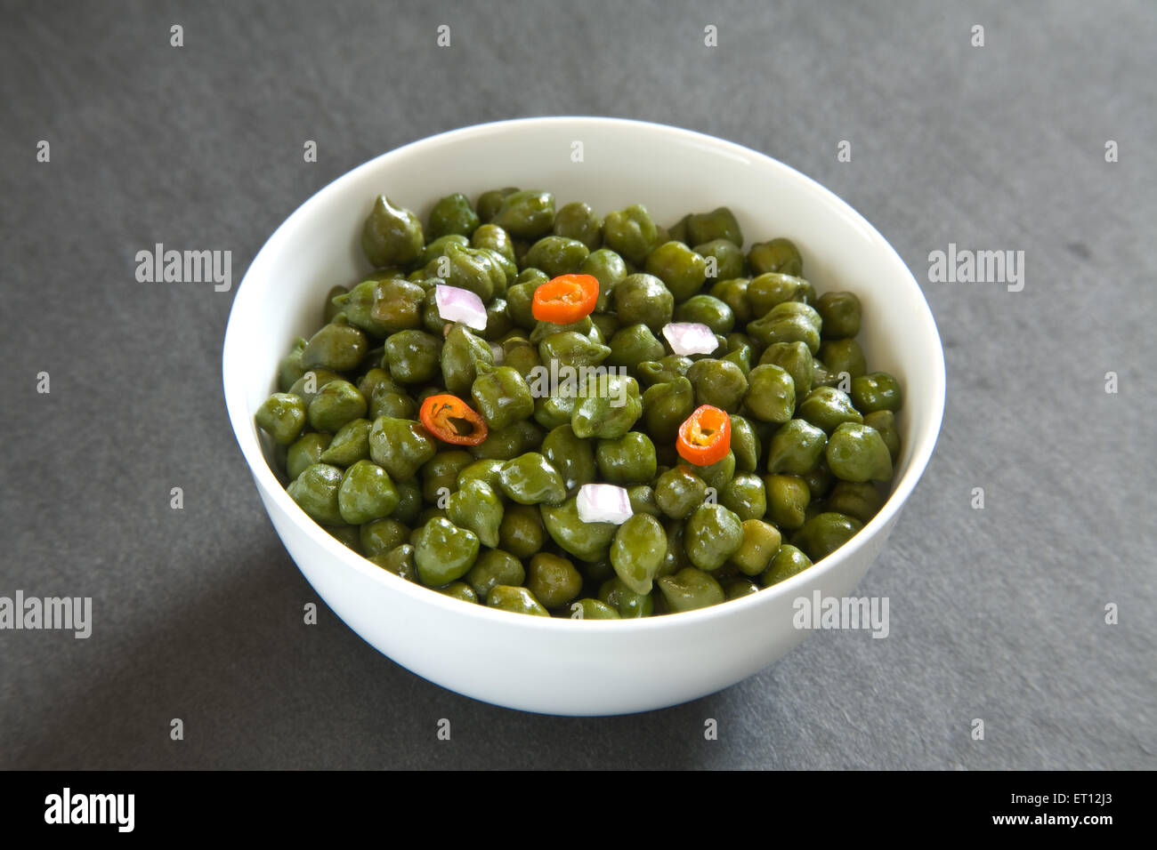 Indian breakfast green chickpeas chana salad served in bowl on black