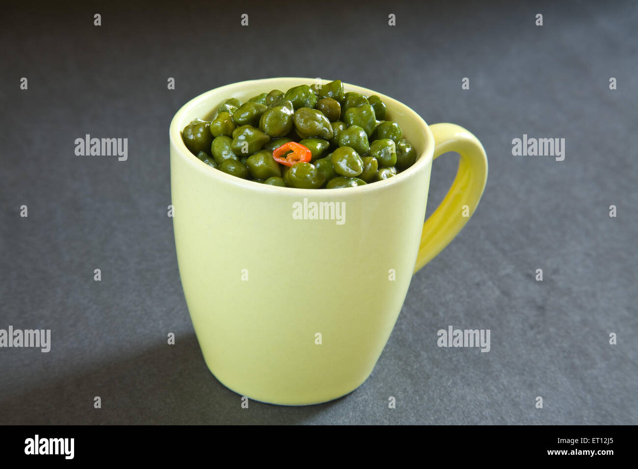 Indian breakfast green chickpeas chana salad served in mug on black