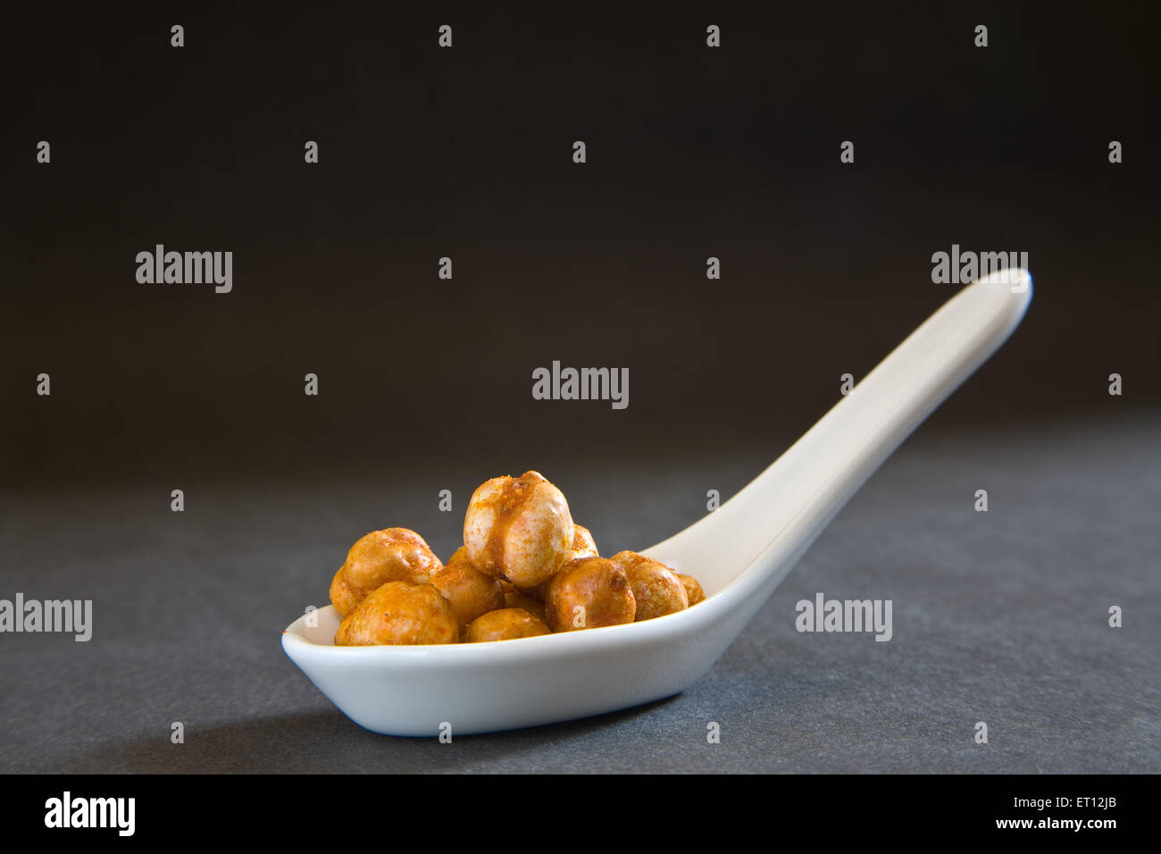 Indian breakfast fry chickpeas chana masala served in spoon on black background 12 May 2010 Stock Photo