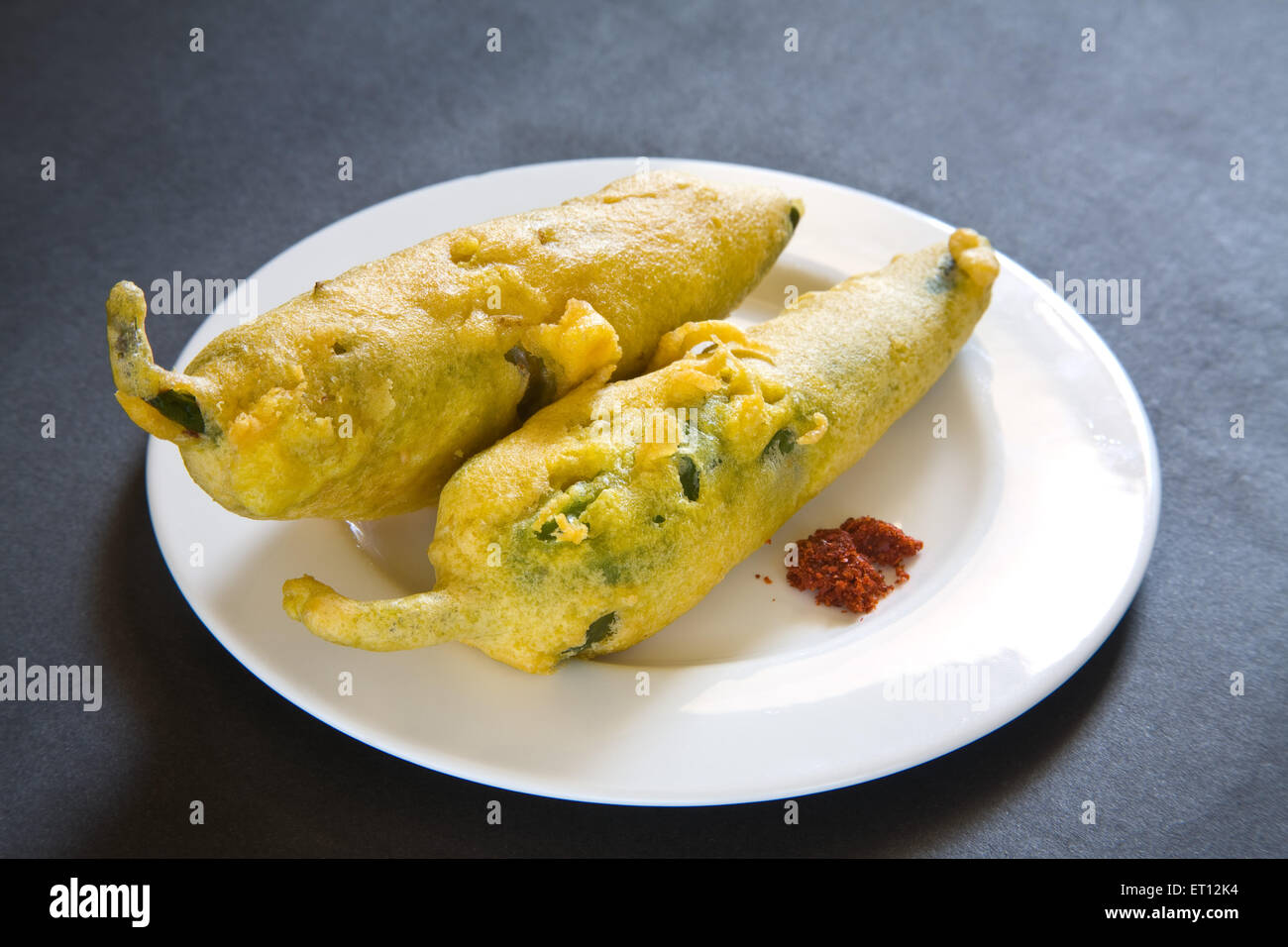 Indian fast food fried chilli vada mirchivada with red chutney served