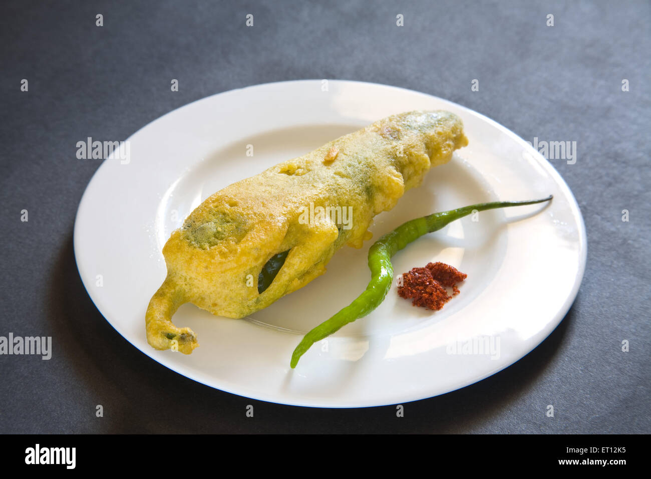 Indian fast food fried chilli vada mirchivada with red chutney and