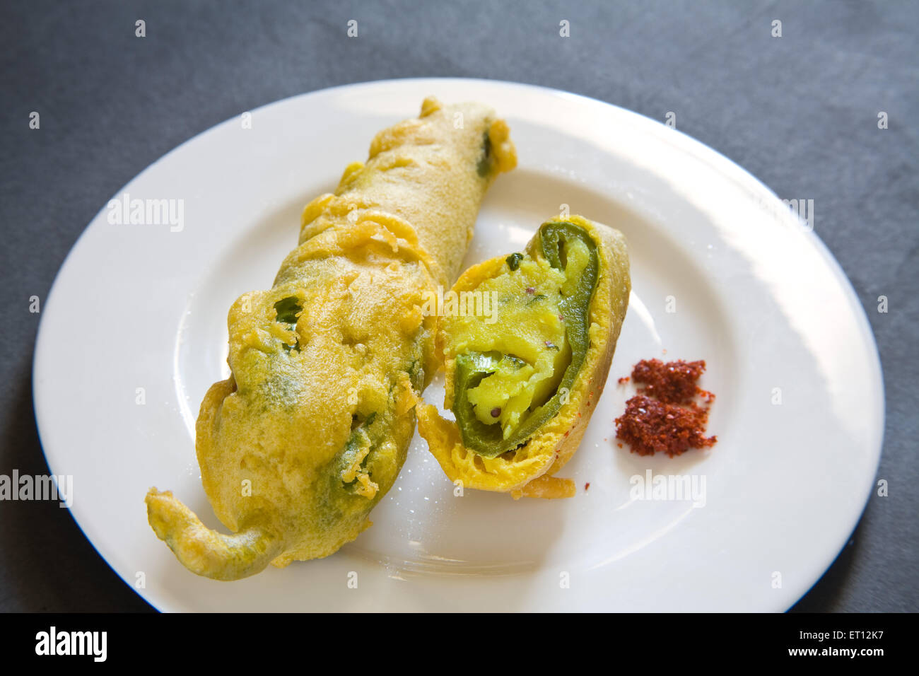 Indian fast food fried chilli vada mirchivada with red chutney served
