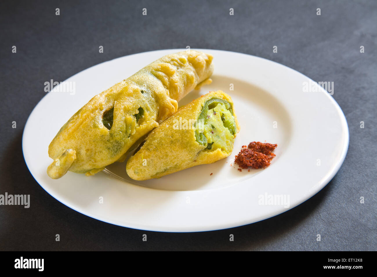 Indian fast food fried chilli vada mirchivada with red chutney served
