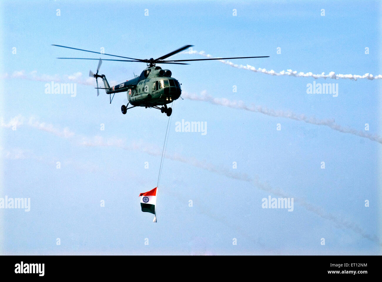 Indian Navy helicopter flying with National Flag on Air Force Day ; Trivandrum ; Thiruvananthapuram ; Kerala ; India Stock Photo