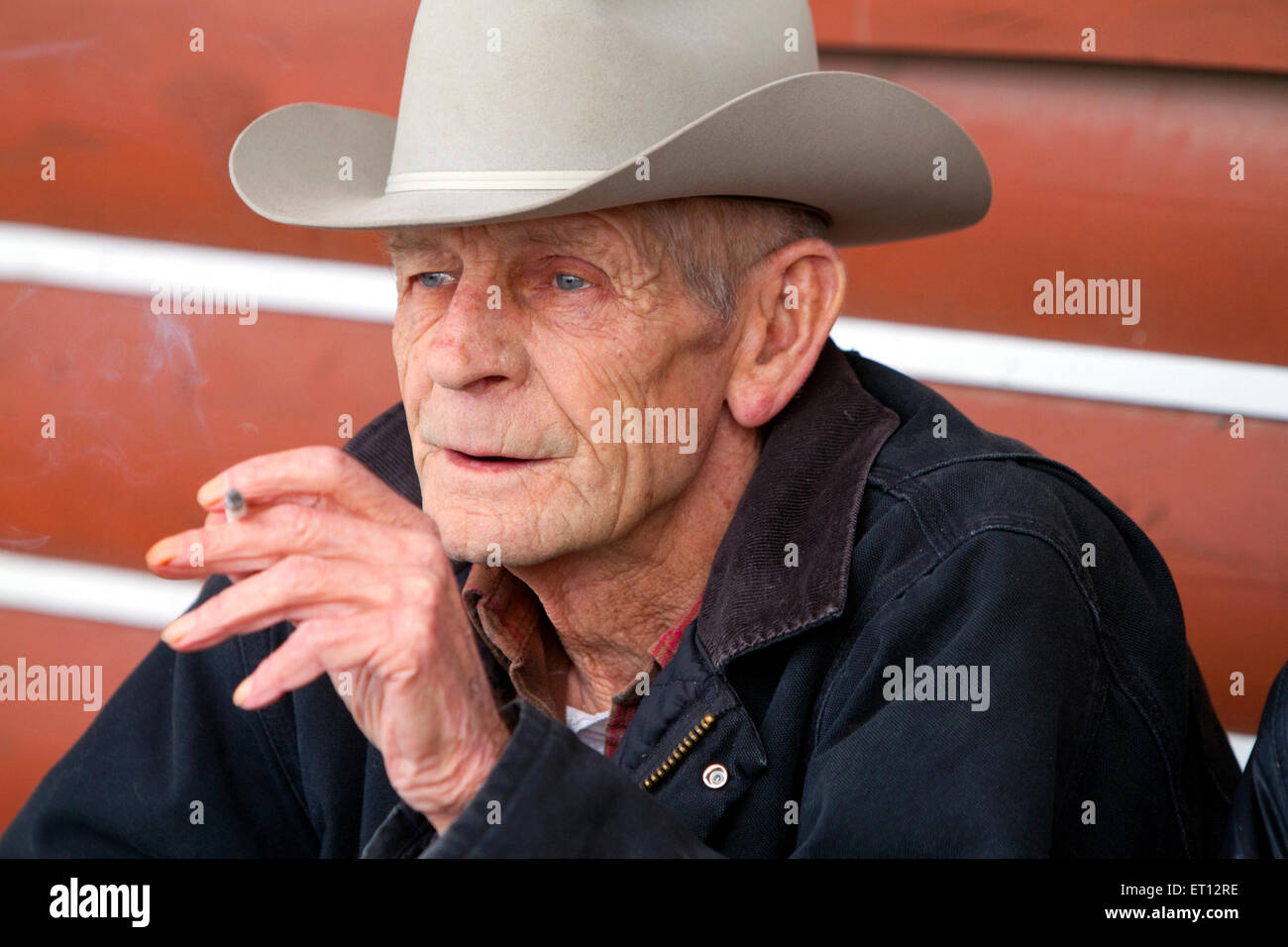 Old farmer smoking a cigarette outside a cafe in eastern Idaho, USA. Stock Photo