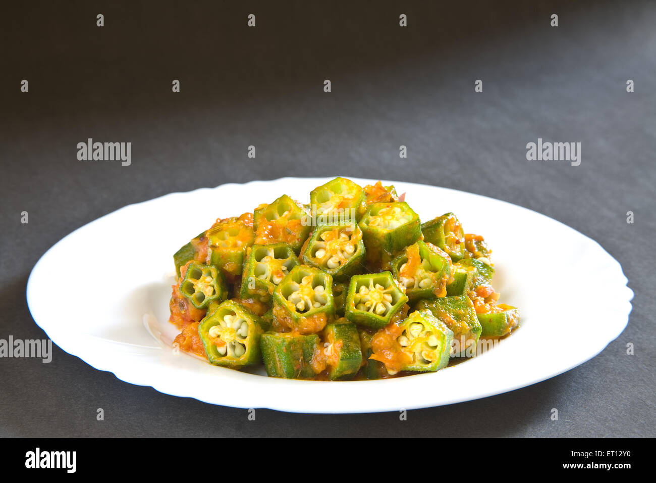 Indian cuisine masala lady finger okra hibiscus esculentus served in plate on black background 17 May 2010 Stock Photo