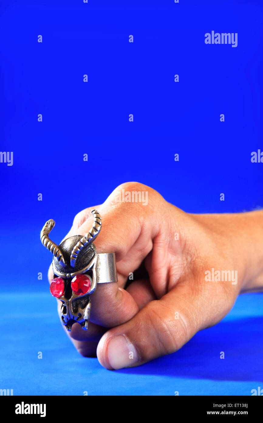 Modern fashion ring on finger ; blue background ; Bombay Mumbai ; Maharashtra ; India MR#201 Stock Photo