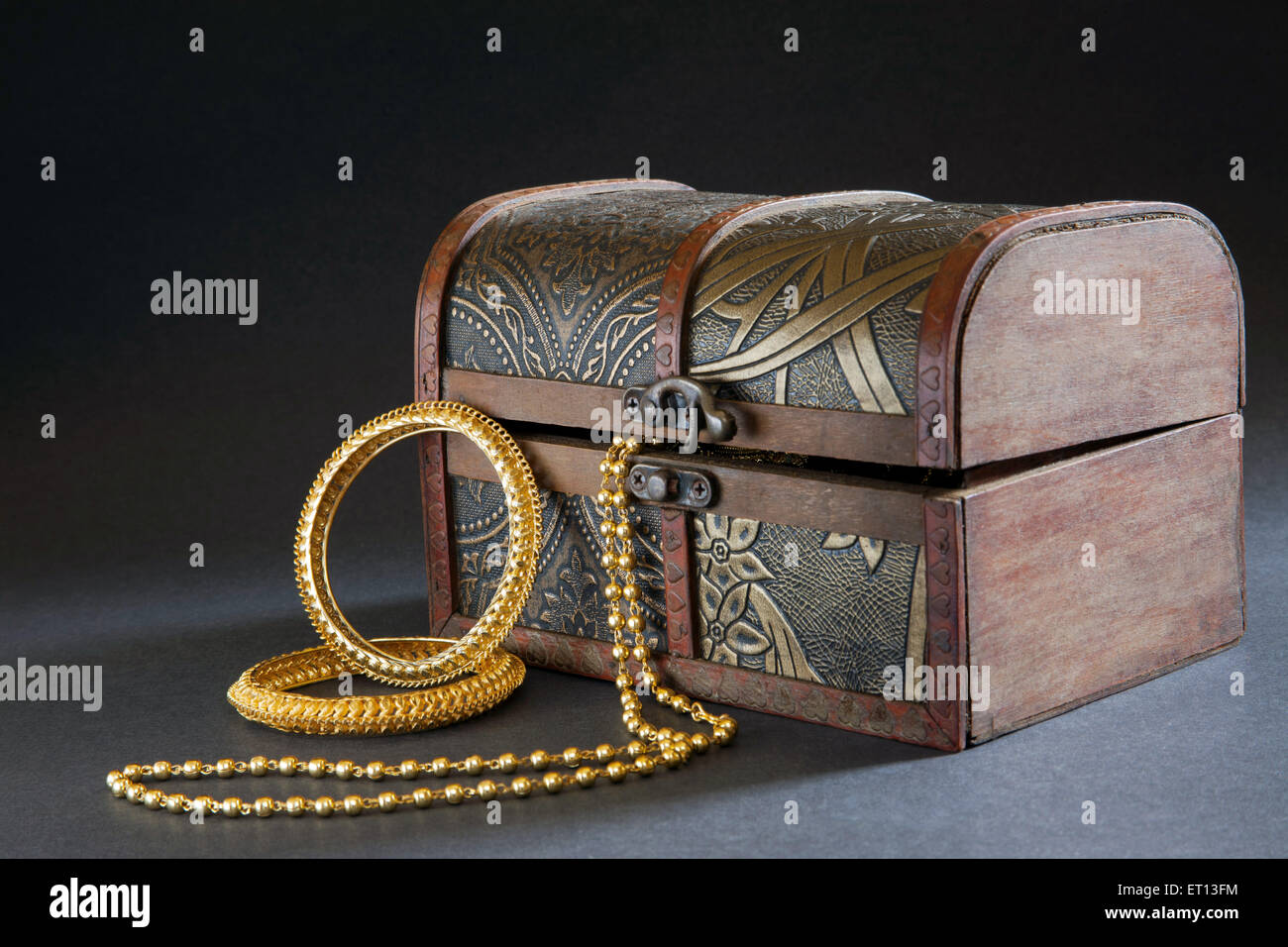 Wooden Jewellery box with Gold Bangles Necklace and Ring India Asia Nove 2011 Stock Photo
