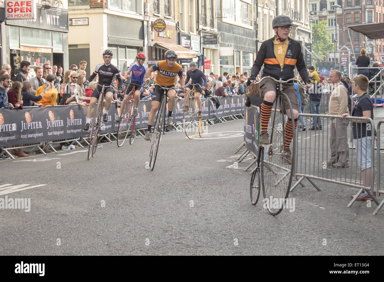 LONDON, UNITED KINGDOM, 6TH JUNE 2015 - Cyclists compete at the London Nocturne's Penny Farthing Race in Smithfield. Stock Photo