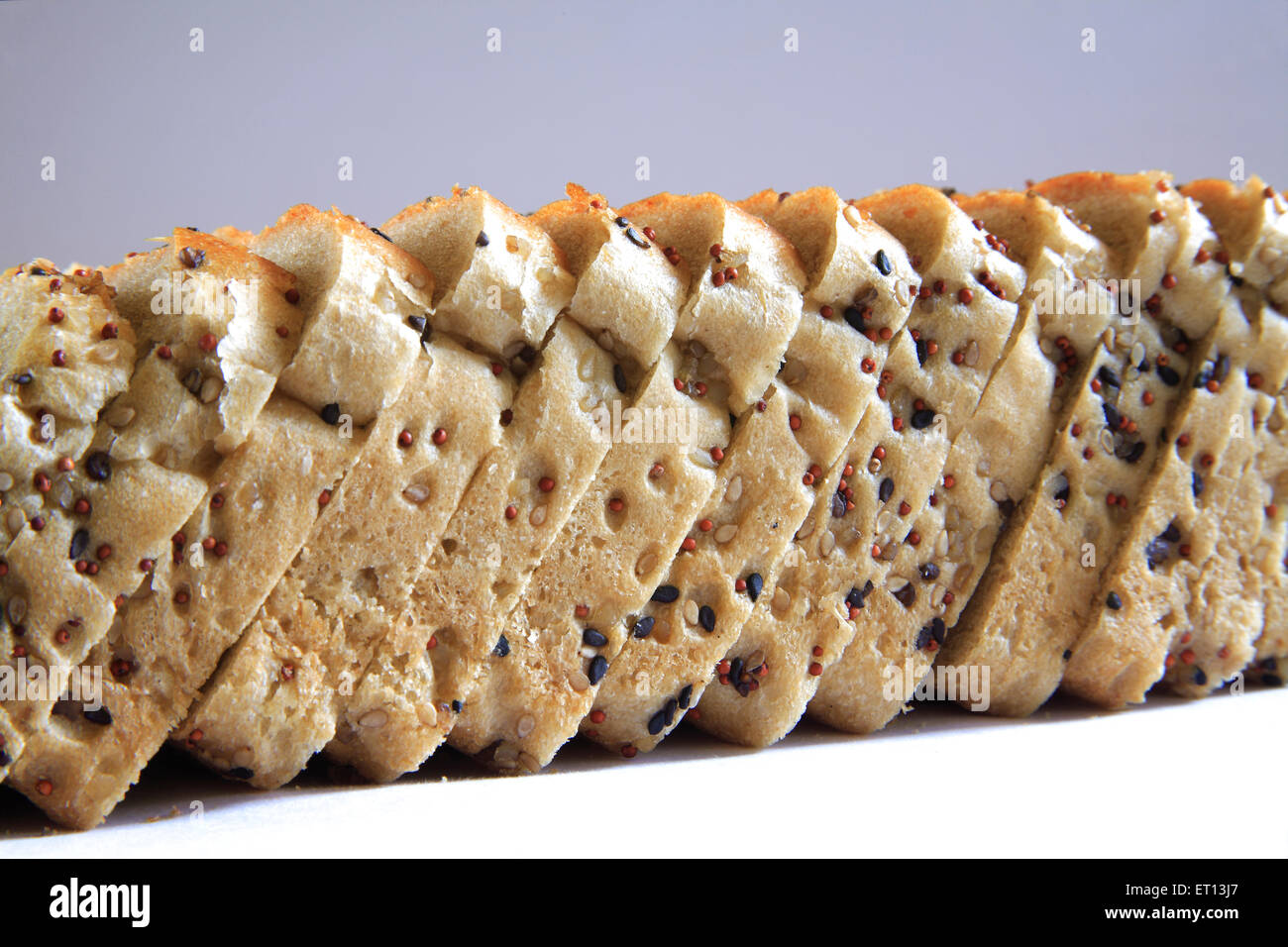 Sesame seeds wheat bread , multigrain pure vegetarian wheat bread slices with white and black sesame seeds on white background Stock Photo