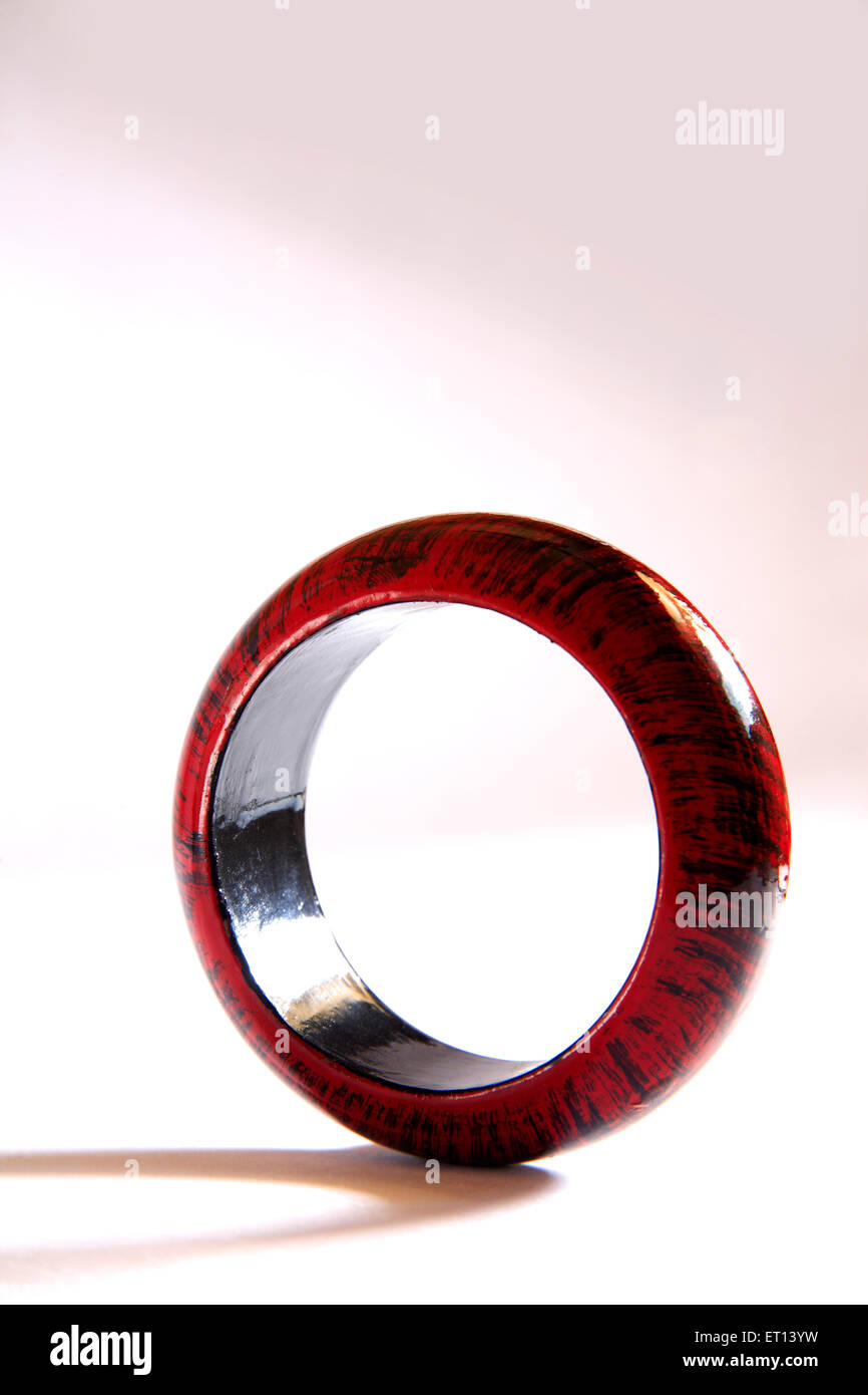 Maroon and black colors on wooden bangle on white background Stock Photo