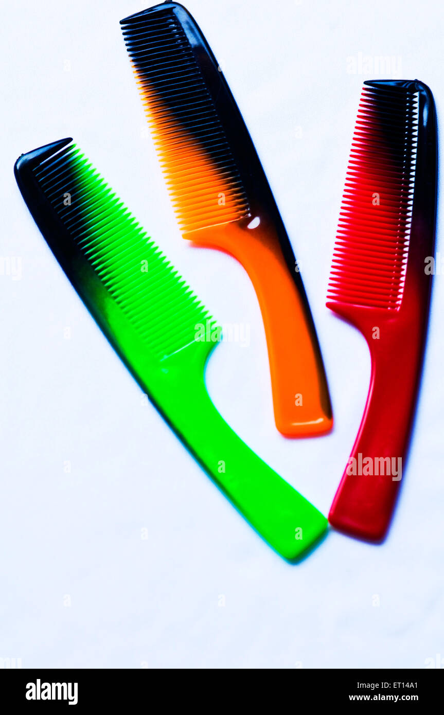 green orange red combs on white background Stock Photo