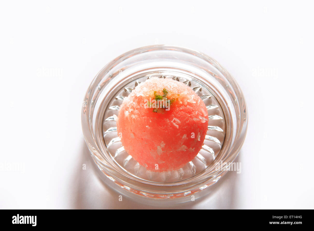 One piece of bengali mithai raskadam garnish with coconut and pistachio