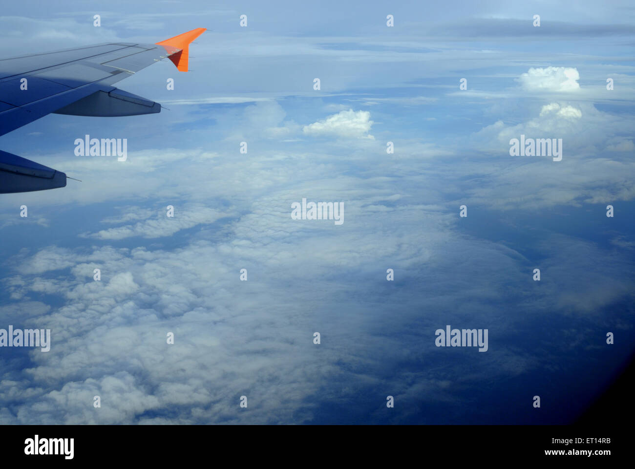Aerial view of clouds and aircraft wing Stock Photo - Alamy